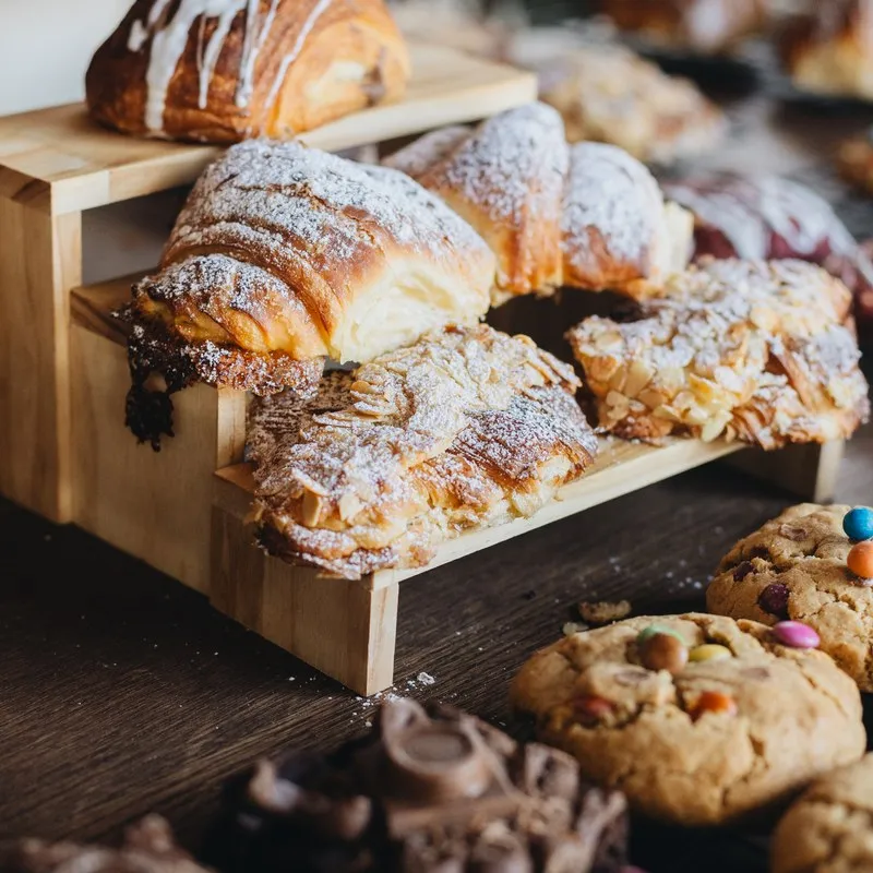 Croissants, pastries and breads on a wooden display
