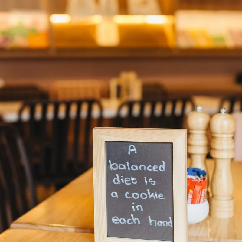 Chalkboard reading 'a balanced diet is a cookie in each hand'