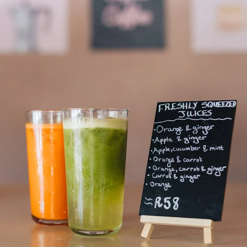 Fresh juices and a green smoothie by the drinks board