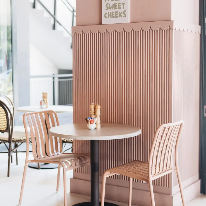 The bright, blush-toned interior of the cafe